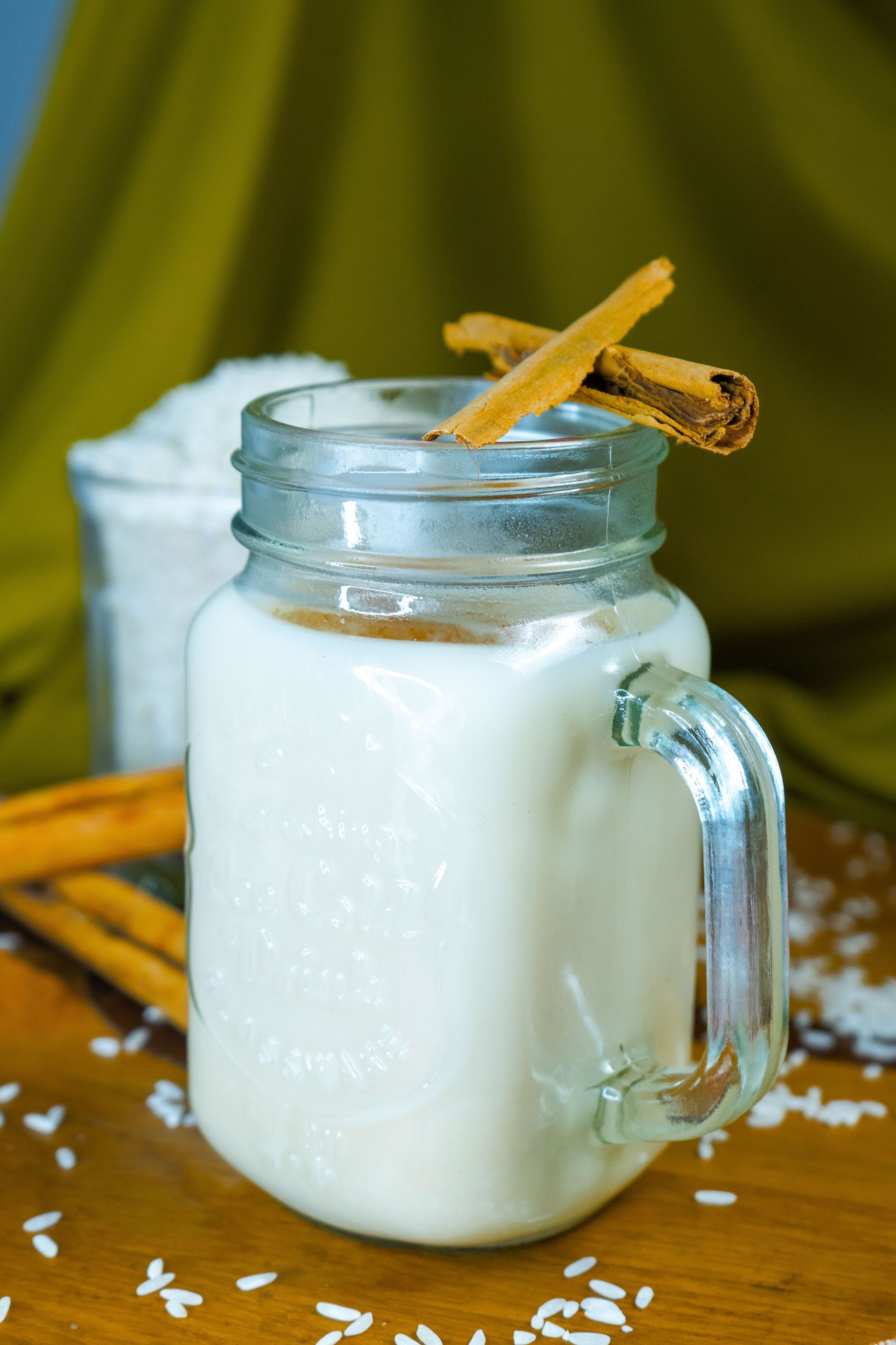 Delicious Mexican horchata drink in a glass mug, garnished with cinnamon sticks. Perfect for refreshing summer days.